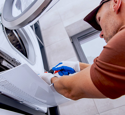 A man deep cleaning a dryer